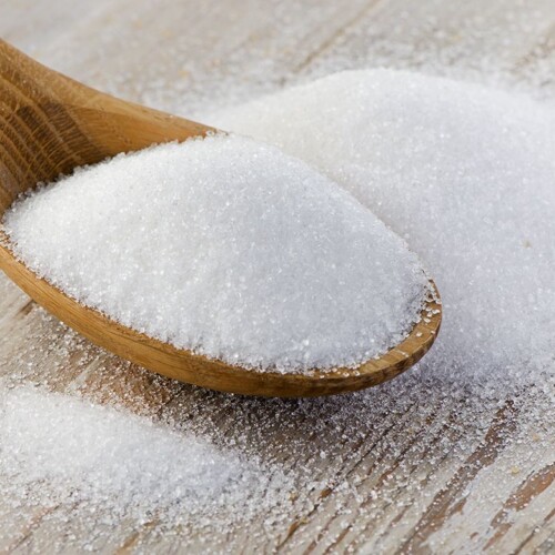 1-2 Taste AllSWEET Allulose Crystalline Powder in a wooden spoon on a rustic surface